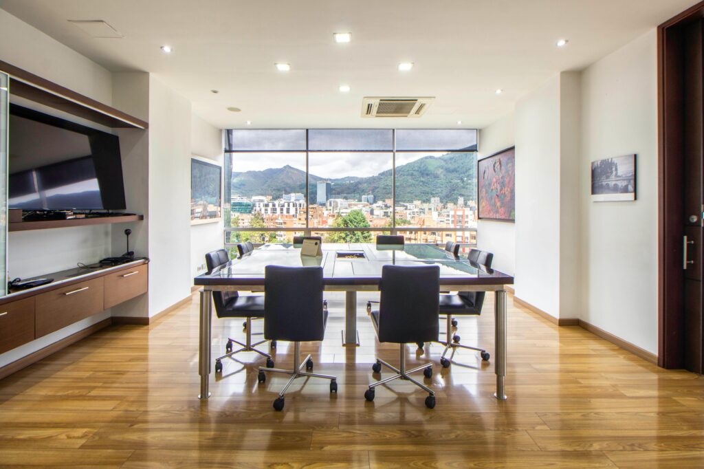 Spacious meeting room featuring contemporary design and city skyline view.